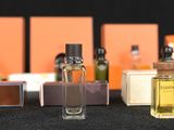 several bottles of perfume are lined up on a table