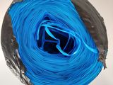 a large roll of blue yarn on a white surface