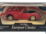 an image of a red toy car in a box with a flag on it