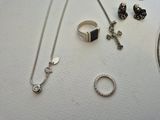 a lot of jewelry that is laying out on the table