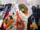 a pile of clothes and a pair of scissors on a bed