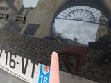 reflection of a person ' s hand on a car ' s rear window