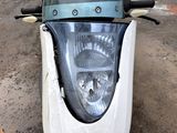 a close up of a motorcycle headlight on a street