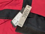 the back of a red jacket with a tag attached to it