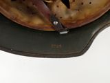 a close up of a helmet with a leather strap on it