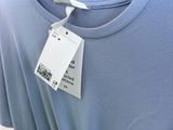 a blue shirt on a hanger in a store