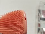 a hair brush that is sitting on a table