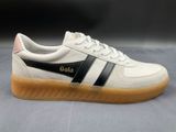 the white and black sneakers are on a gray surface