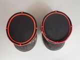 pair of black and red speakers on a white surface