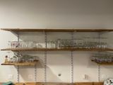 many glasses on the shelves in the kitchen