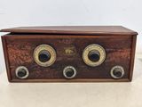an old fashioned radio sitting on top of a table