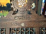 a wooden cabinet with a mirror on top of it