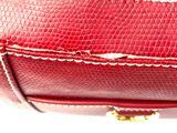 an image of a red purse on a white surface