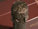 a bronze statue of a man with a hat on a table