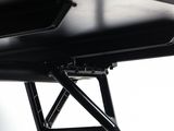 a close up of a black desk with a laptop on it