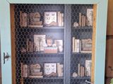 a small cabinet with a book shelf in it