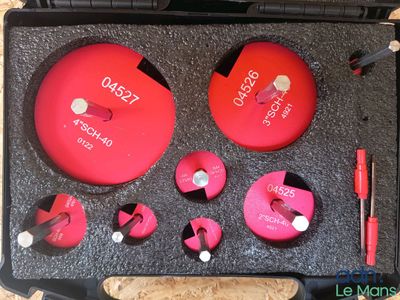 an image of a tool kit with a red disc