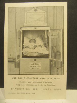 a black and white photo of a baby in a hospital bed