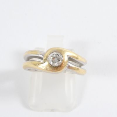a gold and silver ring with a diamond on top