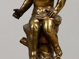 an image of a statue of a boy sitting on a tree stump