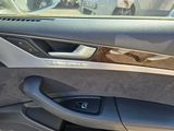 the interior of a car with the door open and the driver ' s seat down