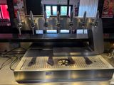 a counter with a bunch of beer taps on it