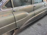 an old car that is parked on the side of the street
