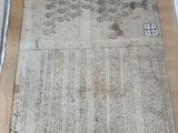 a large piece of paper on a table next to a keyboard