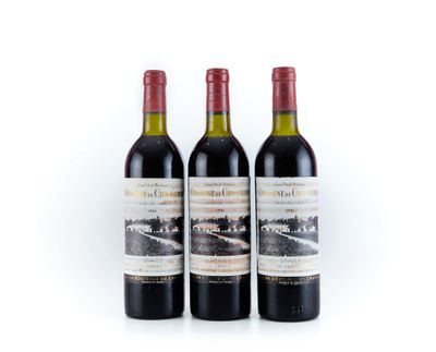 trois bouteilles de vin rouge posées l'une à côté de l'autre sur une surface blanche
