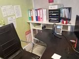 a desk with a chair and a computer on it