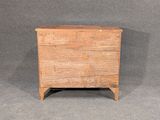 an old wooden chest sitting on top of a gray floor