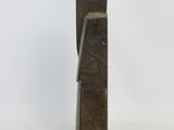 a metal sculpture of a bookend on a white surface