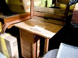 a desk with a chair and a mirror in a room