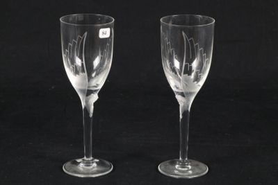 pair of etched wine glasses on a black background