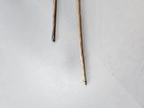 a small table with two wooden sticks on top of it