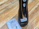 a bottle of liquid sitting on a table next to a plastic container