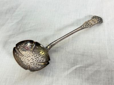a spoon that is sitting on a white cloth