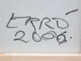 graffiti written on the window of a building with the words erro 2000 written on it