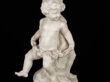 marble statue of a boy with a basket of flowers on a black background