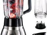 a blender that is sitting next to a glass of water