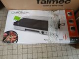 boxed box of a grill with a grill on top of it on a tile floor