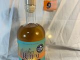 a bottle of liquor sitting on a white sheet