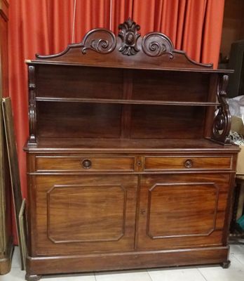 an old wooden china cabinet with a mirror on top of it