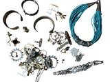 many different types of jewelry on a white surface