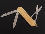 an image of a swiss army knife on a black surface