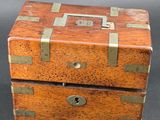an old wooden box with a lock on top of it