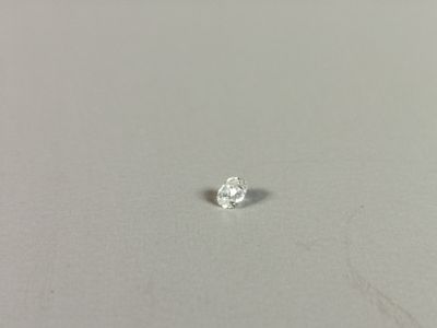 a close up of a single diamond on a white surface