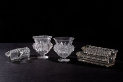 three crystal vases and a box on a black surface