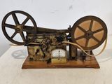 an old fashioned sewing machine on a wooden stand on a white surface
