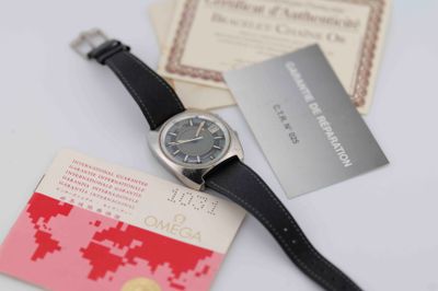 a watch that is sitting on a table next to some cards